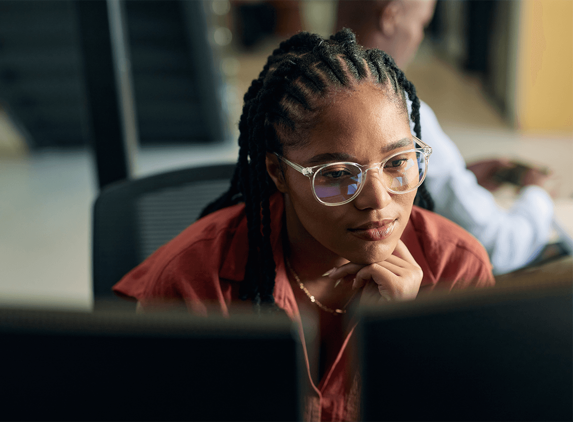 Woman looking at two screens