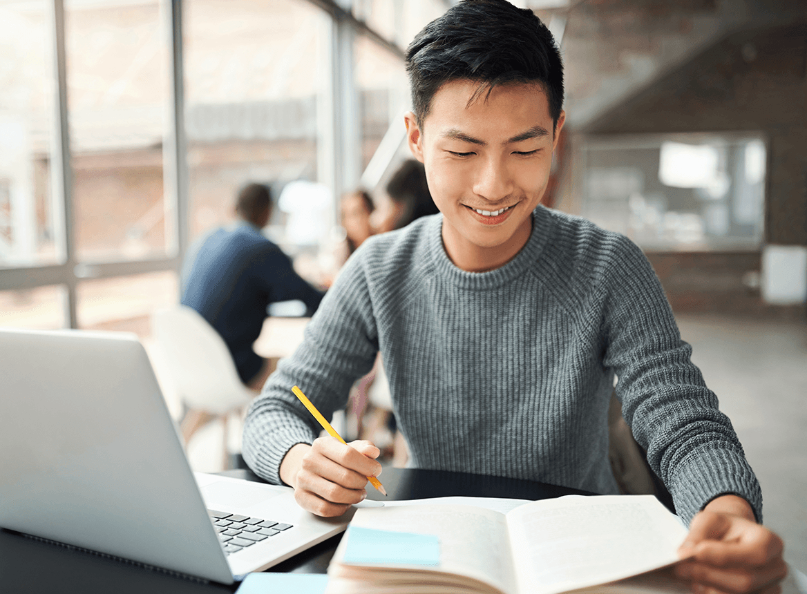 Male working at laptop with notepad