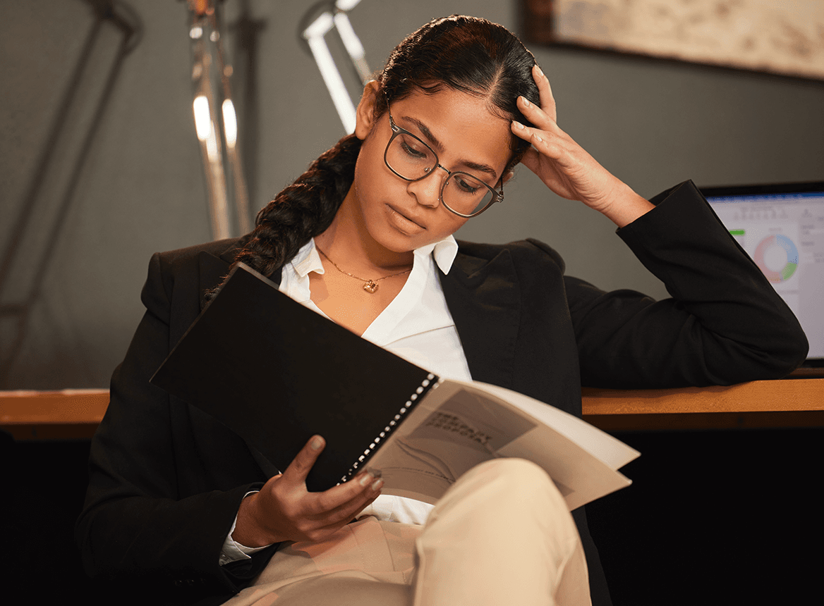 Woman reading a textbook at a desk