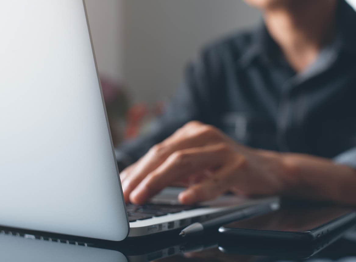 Close Up of Man Typing on Laptop