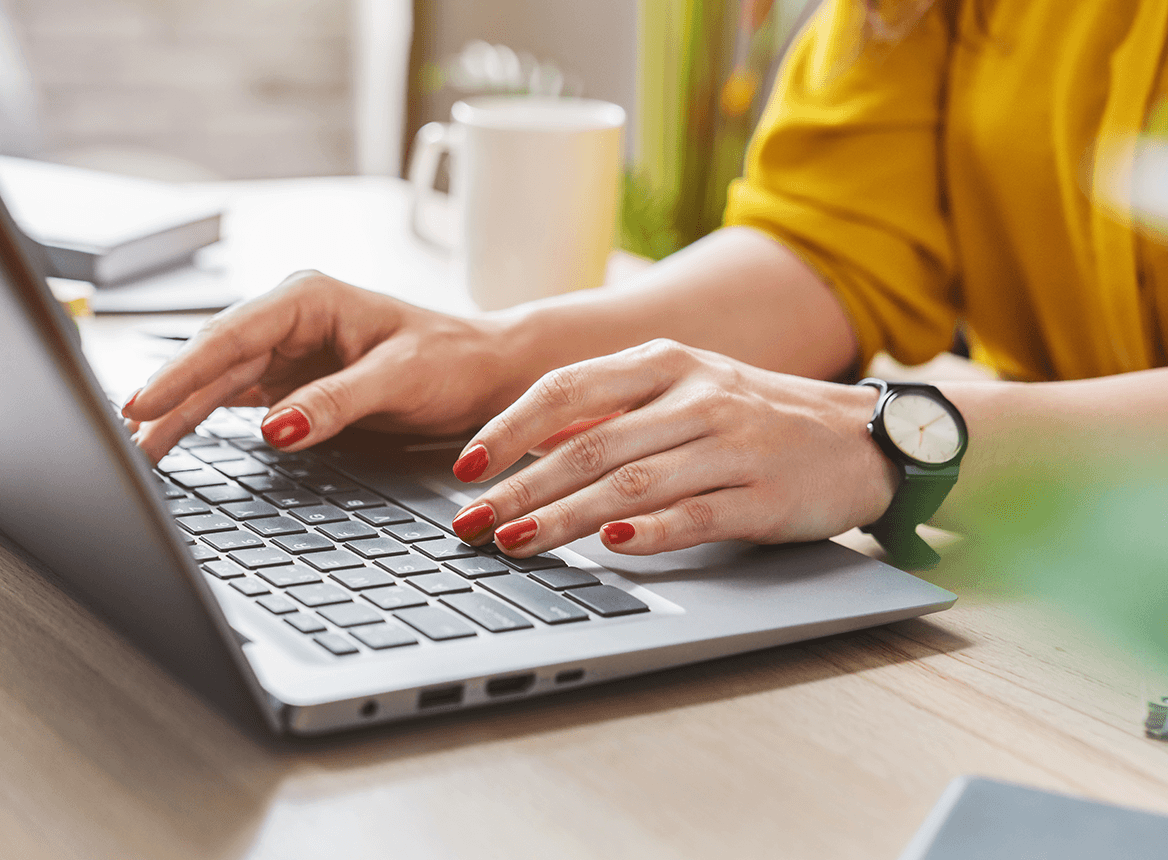 Woman Wearing a Watch Typing on Laptop